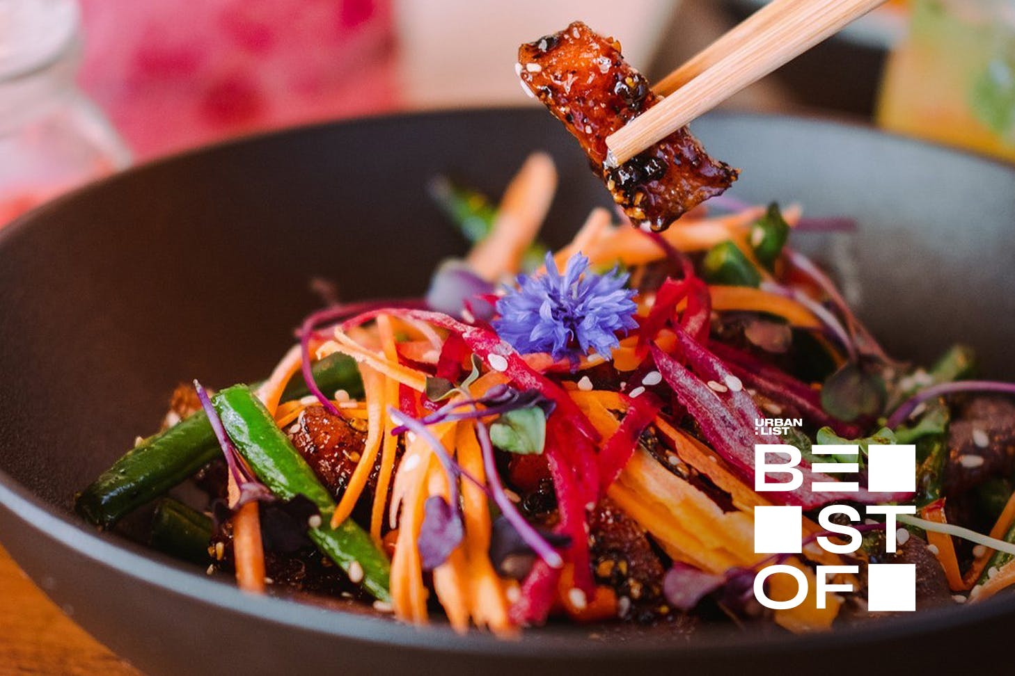 Someone tucks into a delicious dish at Khu Khu, one of the best vegan restaurants in Auckland.